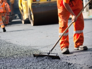 construction workers laying tarmacadam roads